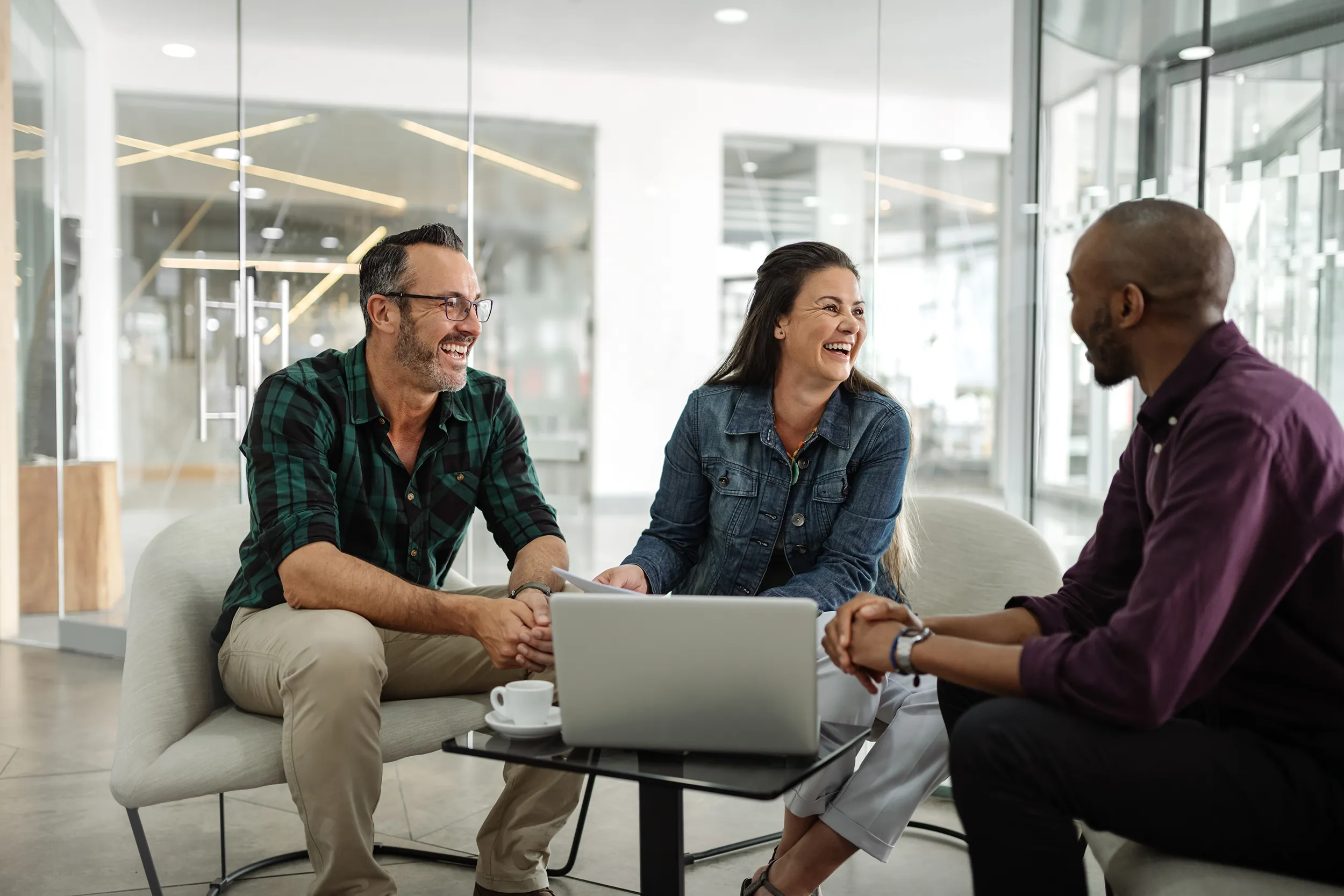 Two men and a woman discussing their strengths during a RockIt Strategy leadership workshop